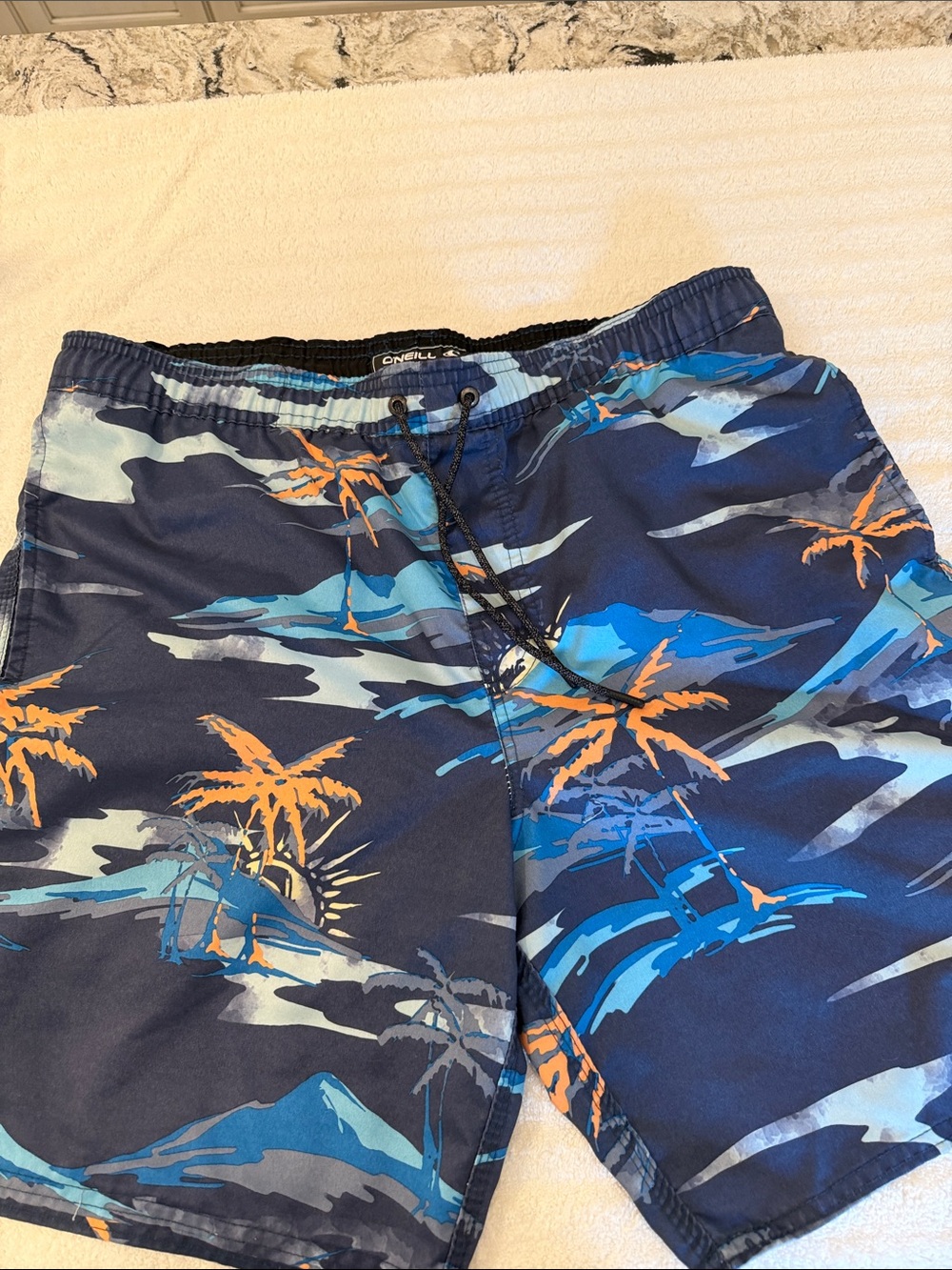 O’Neill bathing suit with two pockets one back pocket with Velcro